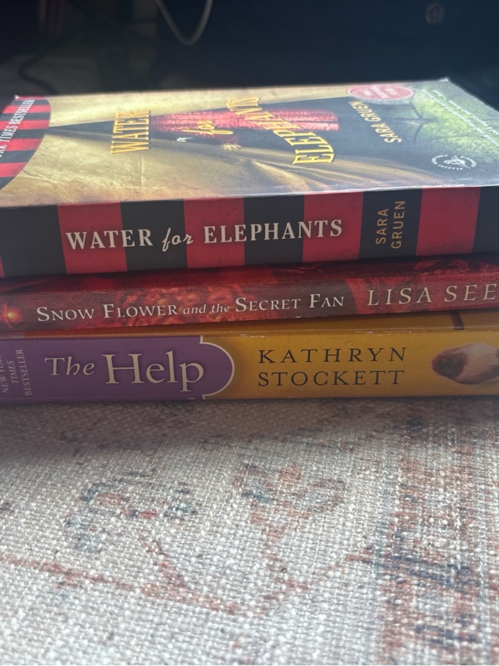 Stack of Three Popular Paperbacks — Red, Maroon, Yellow Covers